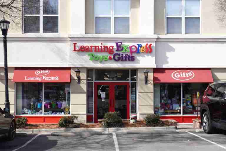 Learning Express storefront with colorful wall sign and red awnings, storefront signage, by Capital Sign Solutions